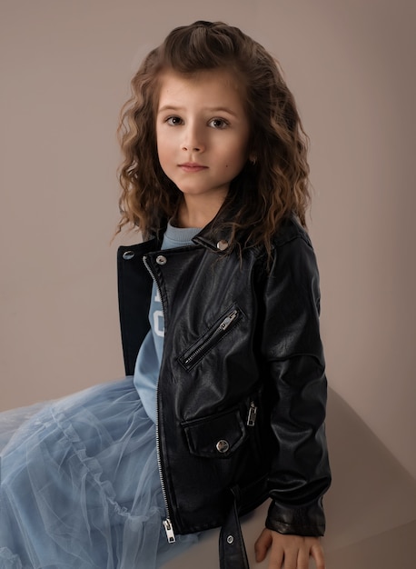 Portrait of a six-year-old girl in a black leather jacket
