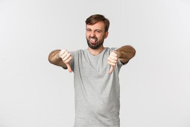 Portrait of skeptical bearded man in casual t-shirt