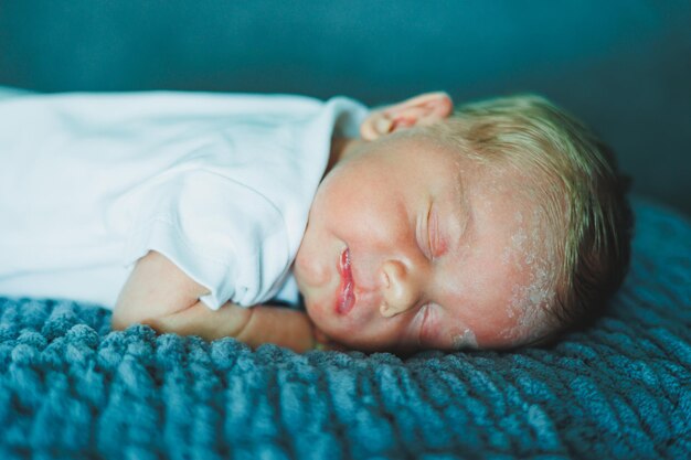 Portrait of a sleeping baby A newborn baby is sleeping A baby in a white cotton bodysuit
