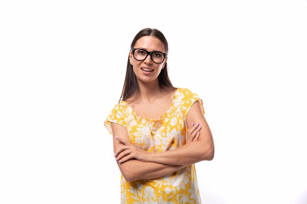 Portrait of a slender young woman with glasses for vision correction on a white background