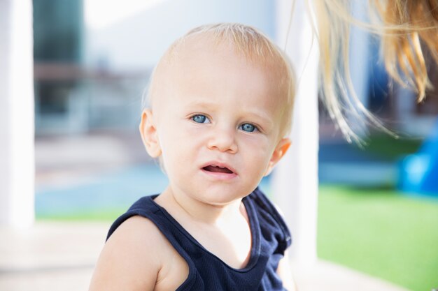 Portrait of small cute blue eyed baby boy outdoor Childhood concept