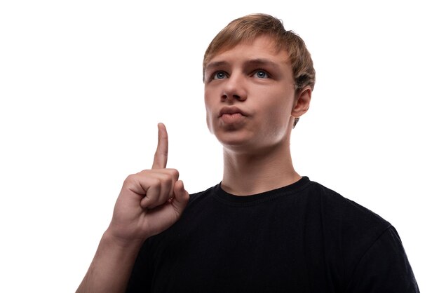 Photo portrait of a smart blond teenager guy holding a thumbs up