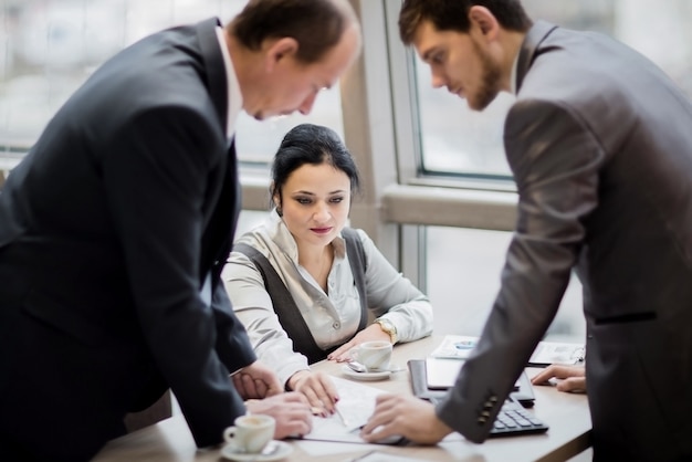 Portrait of smart business partners communicating at meeting