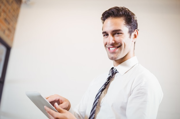 Portrait of smart businessman using digital tablet