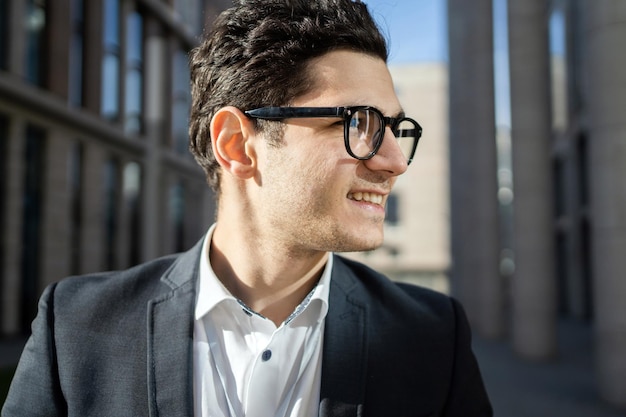 Portrait of a smart manager a man with glasses in a formal suit A confident person goes to work