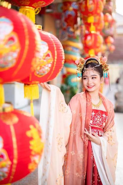 Portrait smile Cute little Asian girl wearing Chinese costumes decoration for Chinese new year festival celebrate culture of china at Chinese shrine Public places in Thailand