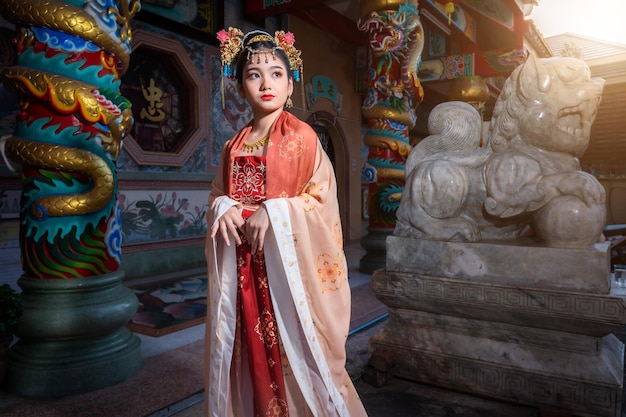 Portrait smile Cute little Asian girl wearing Chinese costumes decoration for Chinese new year festival celebrate culture of china at Chinese shrine Public places in Thailand