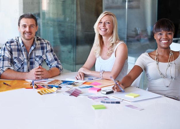 Portrait smile and group of business people at table in meeting together cooperation or collaboration in startup Happy face creative team or designers at desk diversity or brainstorming strategy