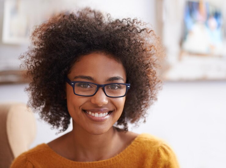 Photo portrait smile and relax woman in home lounge happy and eyewear for natural lady head confidence and glasses with curly hair for female person from london positive in living room or apartment