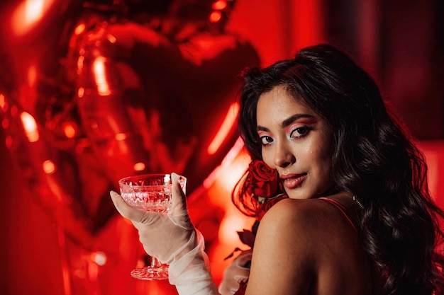 Portrait of smile sexy asian girl glam makeup in lingerie with red roses and coupe glass champagne