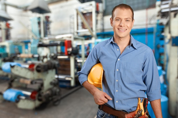 Portrait of smilin male engineer at work in the industry factory.