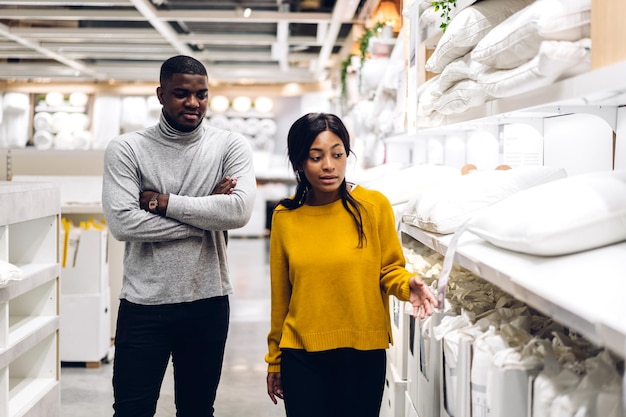 Portrait of smiling african american love couple talk and walking shopping sale and purchases looking choosing to buy something in holiday at storeshopping sale lifestyle concept