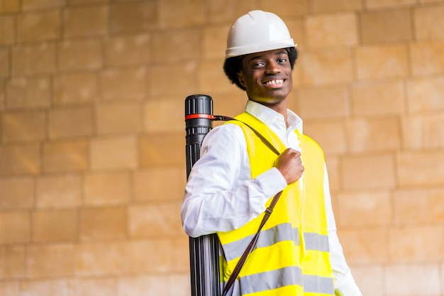 Portrait of a smiling african architect in a construction site