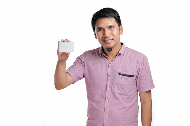 Portrait of smiling Asian man holding white blank business card on white background