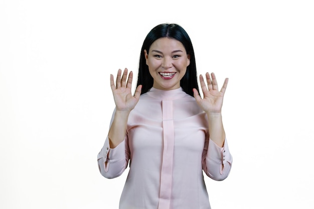 Portrait of smiling asian woman with her hands up Isolated on white background