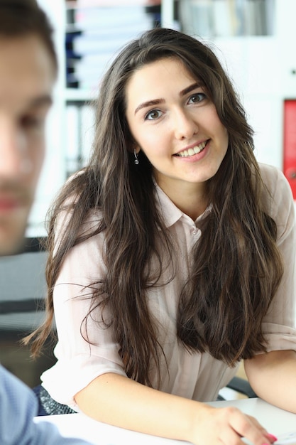 Portrait of smiling assistant at business meeting in office