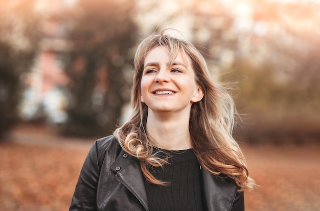 Portrait of smiling beautiful autumn woman outdoors