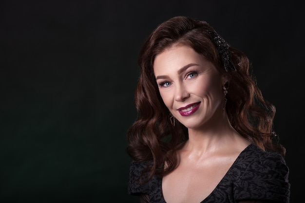 Portrait of a smiling beautiful senior woman with dark hair