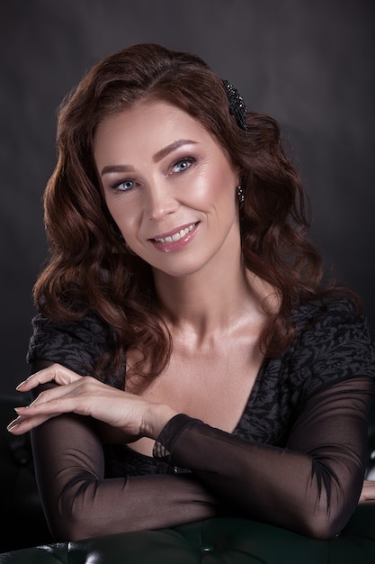 Portrait of a smiling beautiful senior woman with dark hair