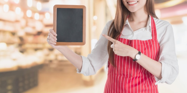 Portrait of smiling beautiful young asian woman wear red apron