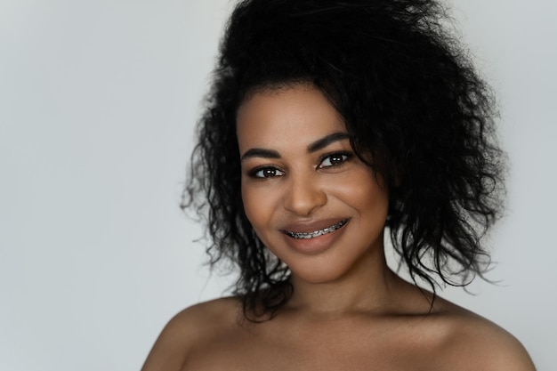 Portrait of smiling black woman with dental braces on her teeth