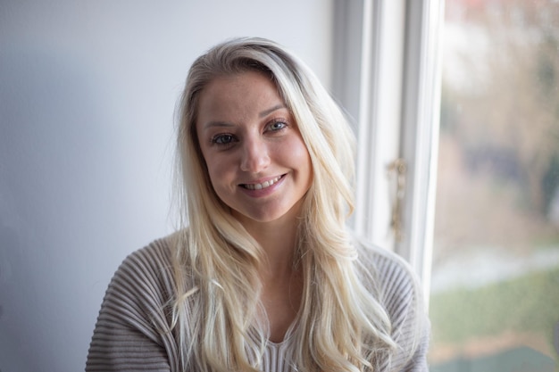 Portrait of a smiling blond girl attractive happy caucasian woman