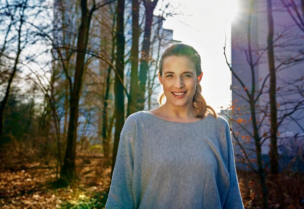 Portrait of smiling blond woman at backlight