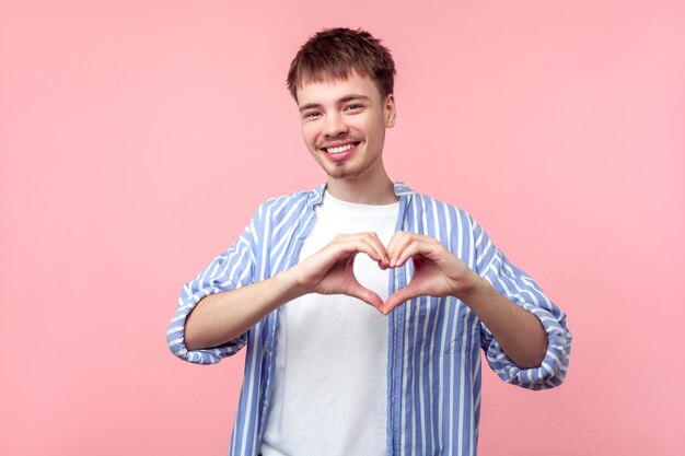 Portrait of smiling boy against gray background