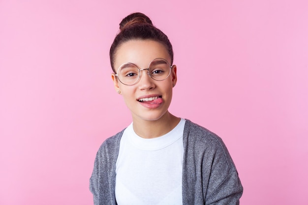 Portrait of smiling boy against pink background