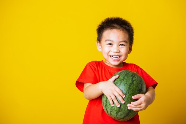 Portrait of smiling boy against yellow background