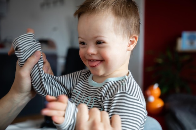 portrait of smiling boy holding baby at home