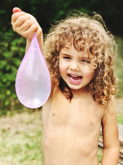 Portrait of smiling boy holding balloon