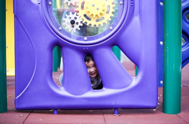 Foto ritratto di un ragazzo sorridente che gioca nel parco giochi