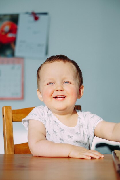 Portrait of a smiling boy sitting on table