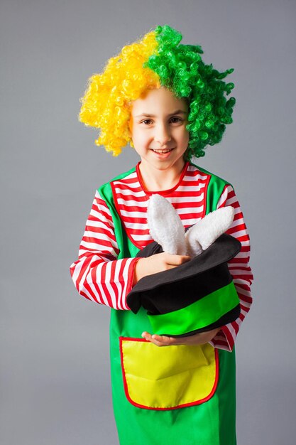 Portrait of smiling boy standing against gray background