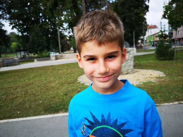 Portrait of smiling boy standing outdoors