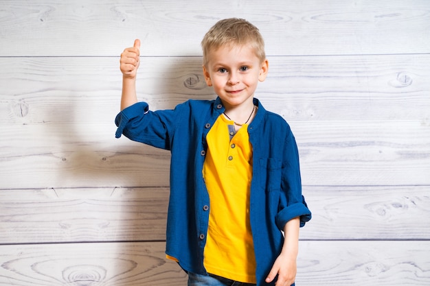 Portrait of a smiling boy with thumb up