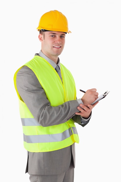 portrait of a smiling builder holding a clipboard