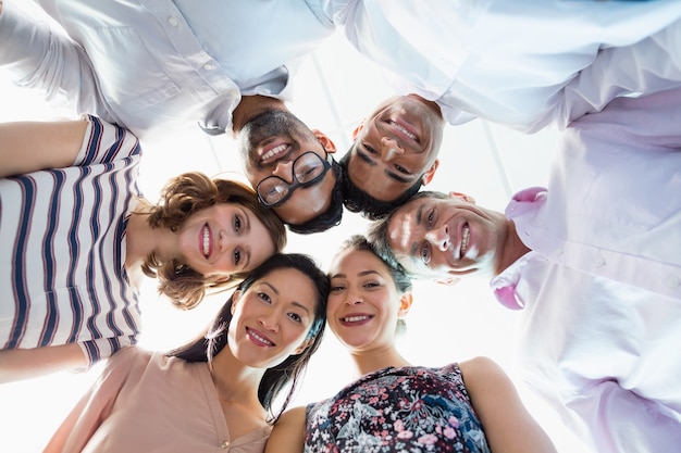 Portrait of smiling business colleagues forming hurdle