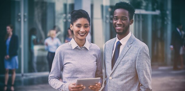 Portrait of smiling business colleagues outside office