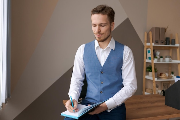 Portrait smiling business man with beard working in office on some project he