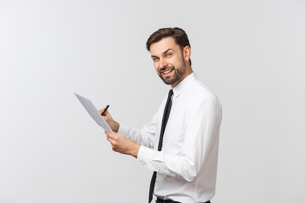 Portrait of a smiling business man with documents isolated on white.