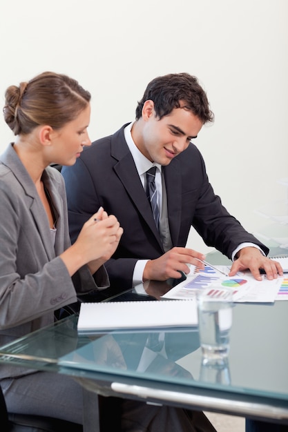 Portrait of a smiling business team studying statistics