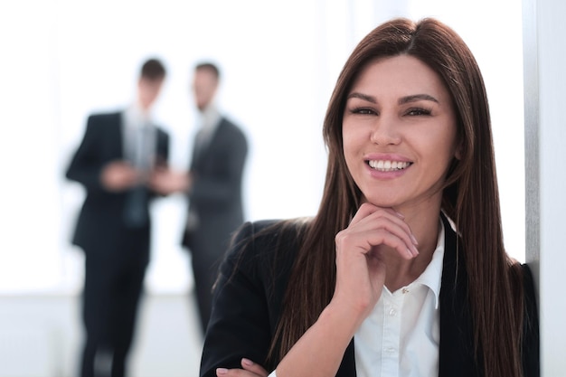 Portrait of smiling business woman on blurred office backgroundphoto with copy space