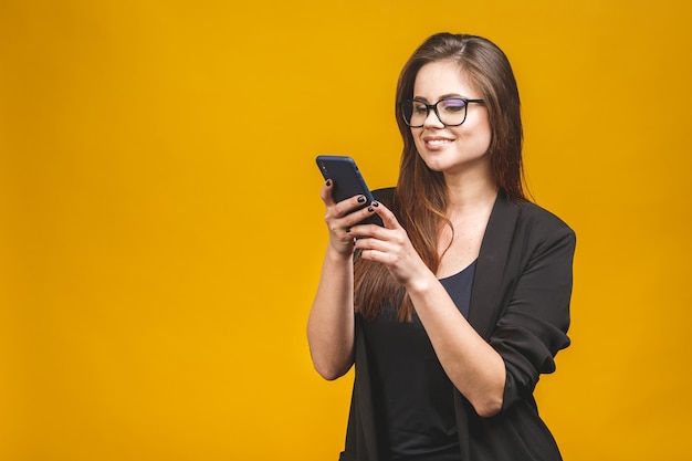 Portrait of smiling business woman in eyeglasses holding smartphone