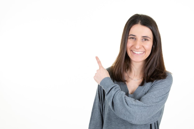 Portrait of smiling business woman pointing finger on white background copy space empty blank