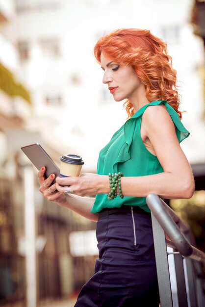 Portrait of smiling business woman using tablet pc