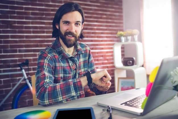 Portrait of smiling businessman checking time 