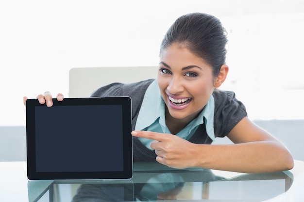 Portrait of smiling businesswoman displaying tablet PC