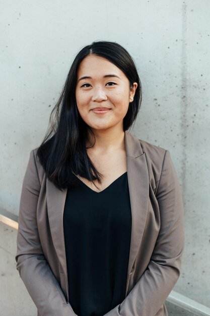 Portrait of smiling businesswoman standing in office